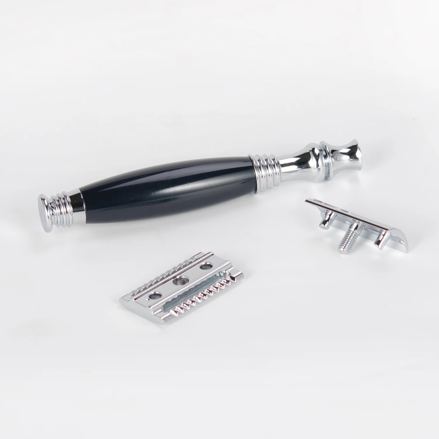 Traditional safety razor with a chrome and black handle, shown disassembled into three parts against a white background.