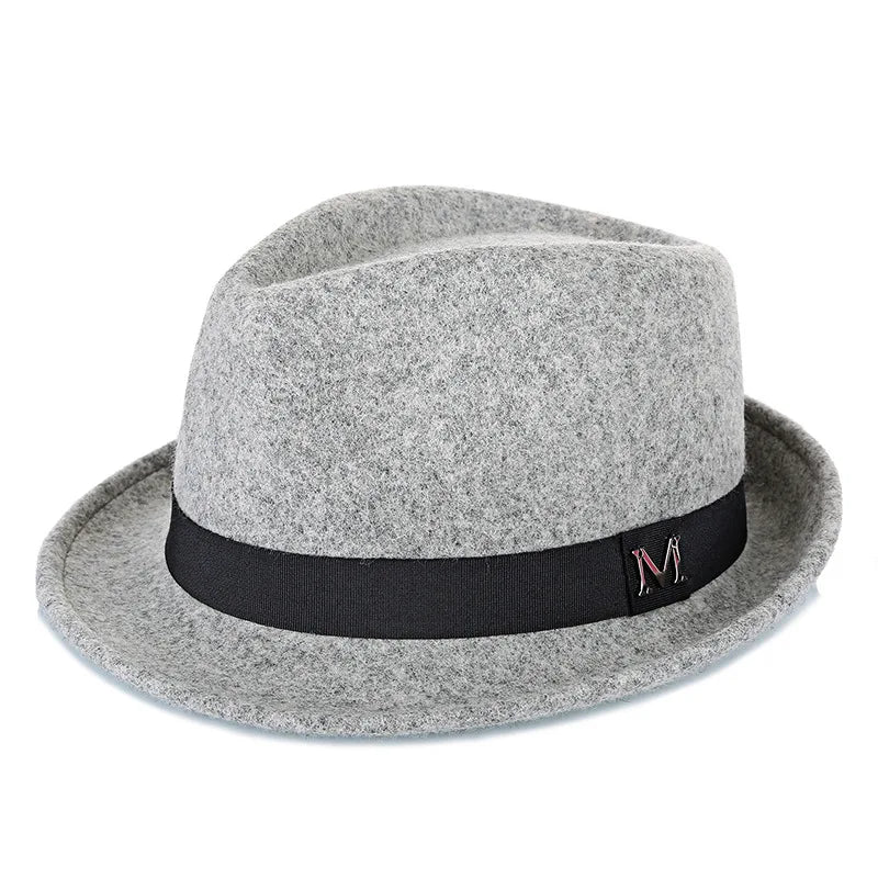 Light grey wool felt fedora hat with a black grosgrain ribbon band and a metal letter detail.