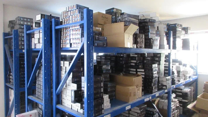 A warehouse storage rack filled with boxes of rechargeable cordless hair clippers and trimmers.
