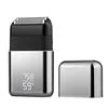 Compact rechargeable silver electric foil shaver with black accents and a digital battery display, shown with its cap.
