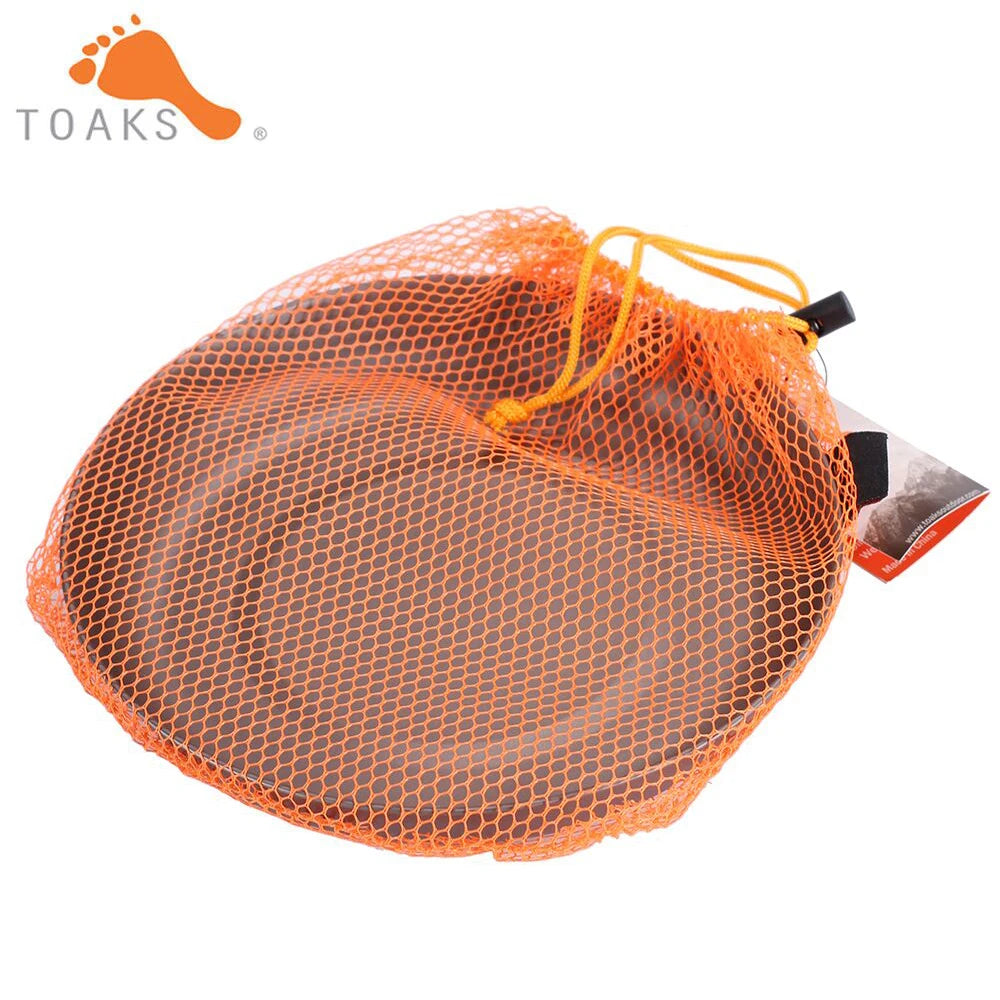 Dark grey titanium plate inside an orange mesh drawstring storage bag.