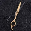 Six-inch hairdressing thinning scissors in a striking gold and black design, set against a dark textured background.