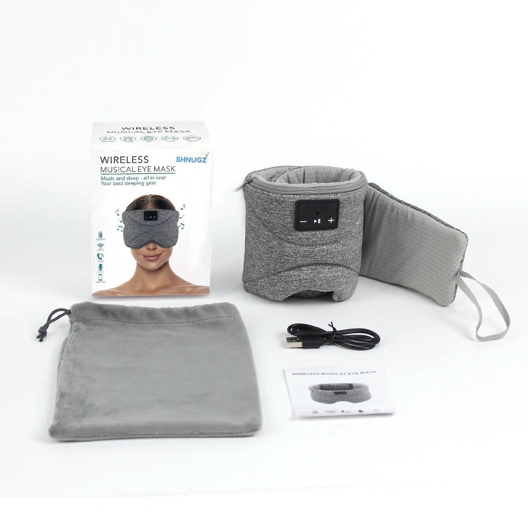 Grey wireless sleep eye mask with built-in headphones, control panel, carry pouch, charging cable, and box.