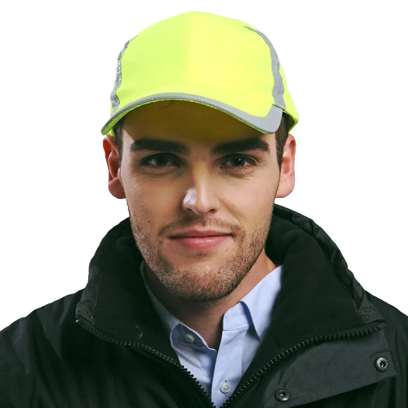 A man wearing a high-visibility, neon yellow baseball cap with grey reflective trim and breathable side panels.