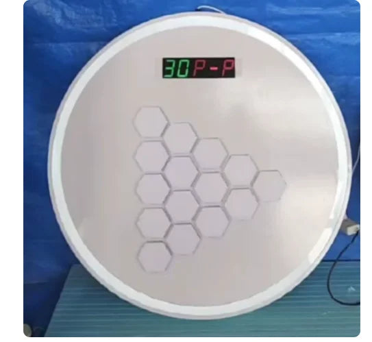 Circular white interactive game board with a digital display and a triangular arrangement of 10 white hexagonal buttons.