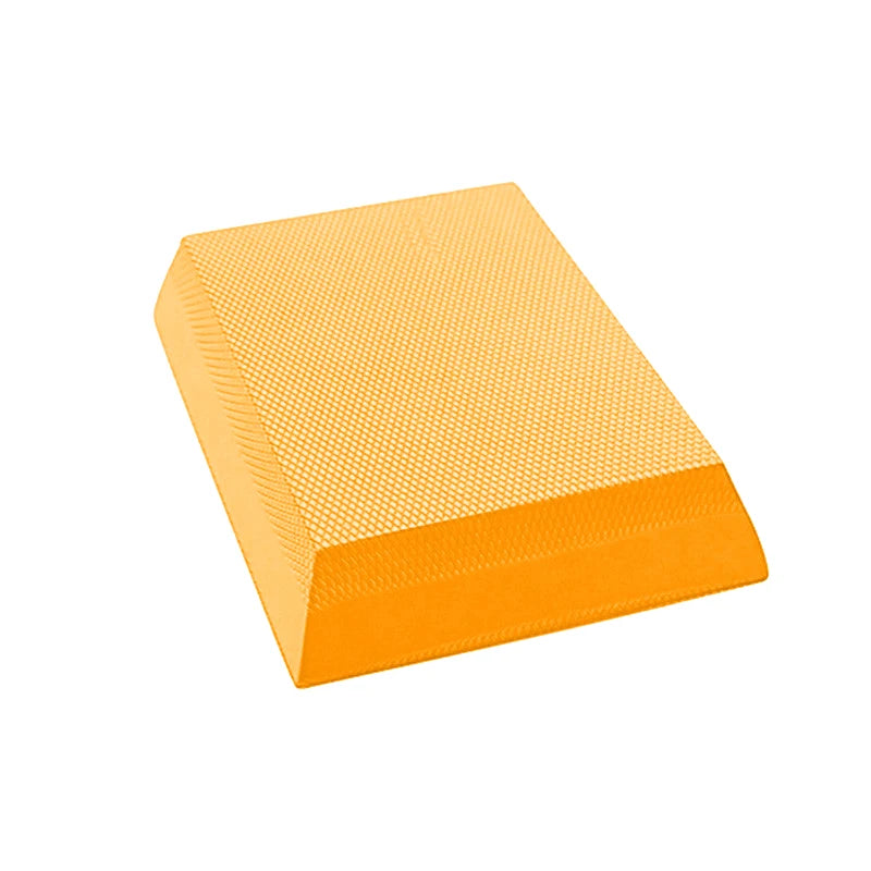Bright yellow TPE foam balance pad with a textured, non-slip diamond pattern surface for stability training.