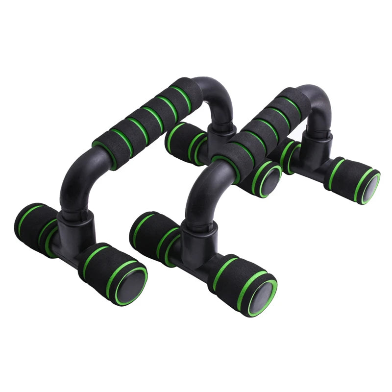 Pair of black push-up bars with green foam-padded grips and handles, isolated against a white background.