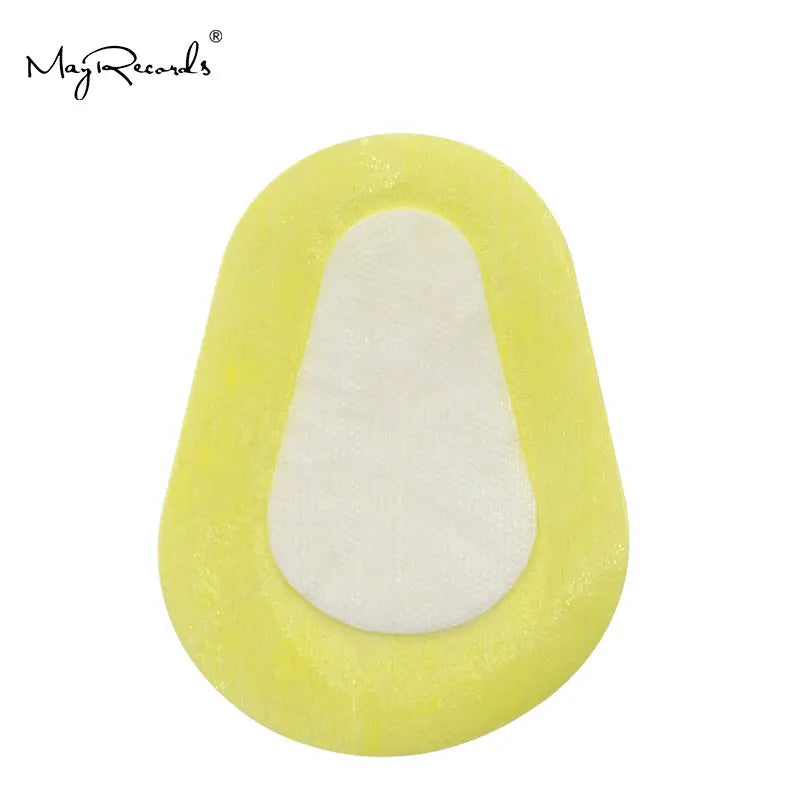 Oval adhesive medical eye patch with a yellow foam border and white fabric center pad on a white background.