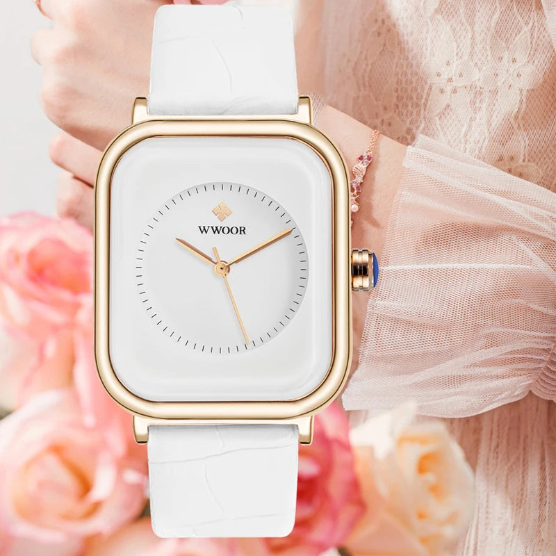 Ladies' watch featuring a square gold-tone case, white dial with gold hands, and a white crocodile-effect leather strap.