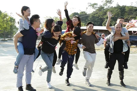 A group of people having fun outdoors, with one person carrying a professional black PU leather laptop backpack.