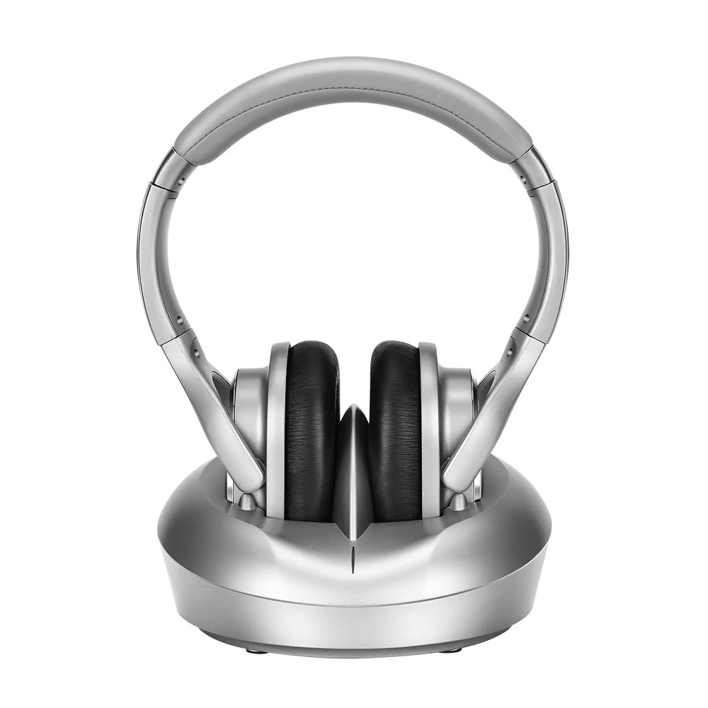 Silver wireless TV headphones with black cushioned ear pads, sitting on a matching silver charging transmitter base.
