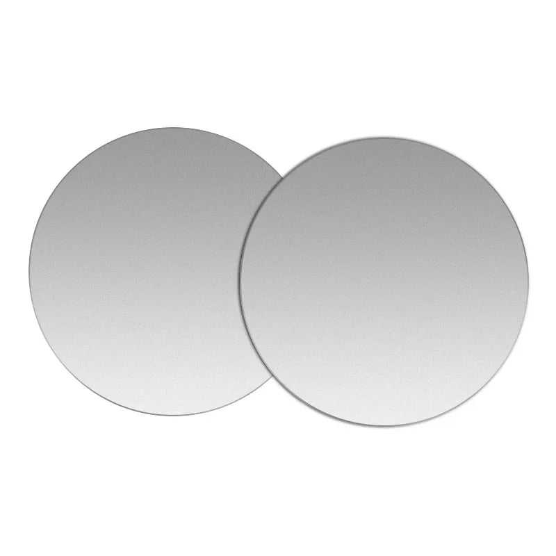 Two circular, matte silver coasters with a minimalist, modern design, shown overlapping on a white background.
