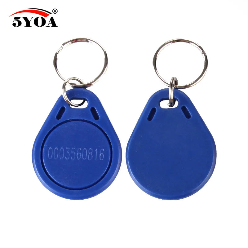 Two blue plastic RFID key fobs with metal key rings; one has a numeric code printed on the surface.