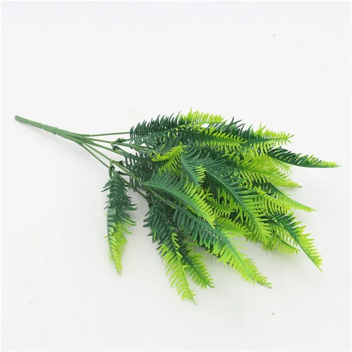 A faux fern sprig with lush, textured fronds in gradient shades of dark and bright lime green on a white background.