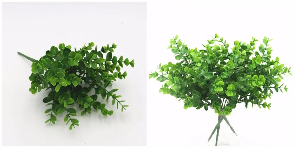 Two clusters of artificial green plastic eucalyptus sprigs with small, rounded leaves against a plain white background.