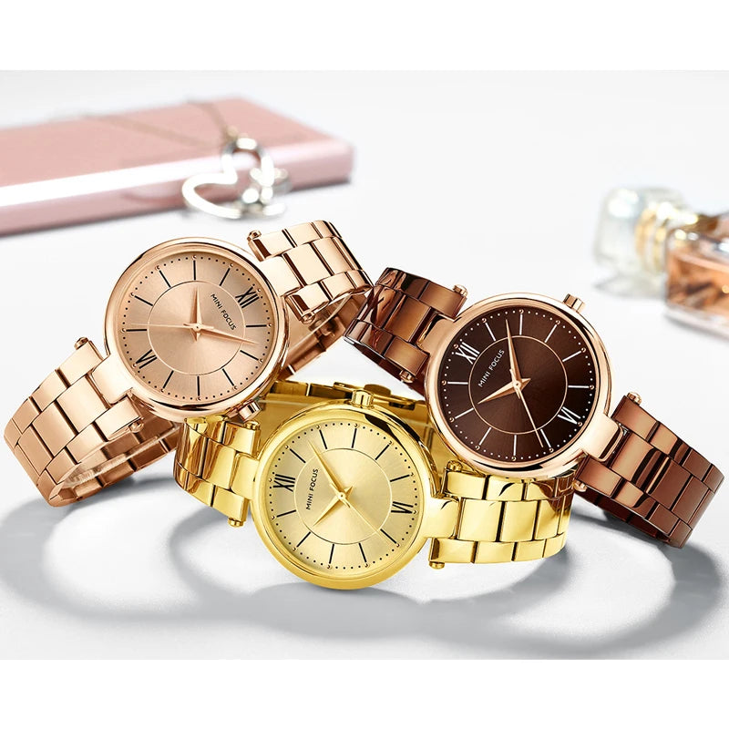 Three MINI FOCUS quartz wristwatches with round faces, link bracelets in rose gold, gold, and brown stainless steel.