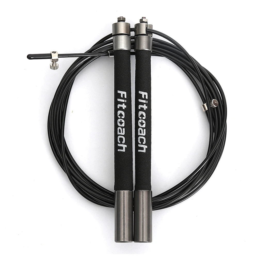 Black speed jump rope coiled with metallic handles featuring "Fitcoach" branding and steel ball bearing tops.