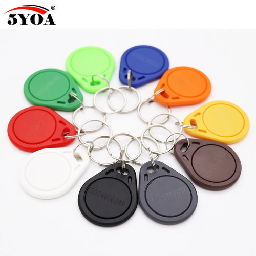 Multi-colored RFID plastic proximity key fob tags with metal key rings arranged in a circle on a white background.