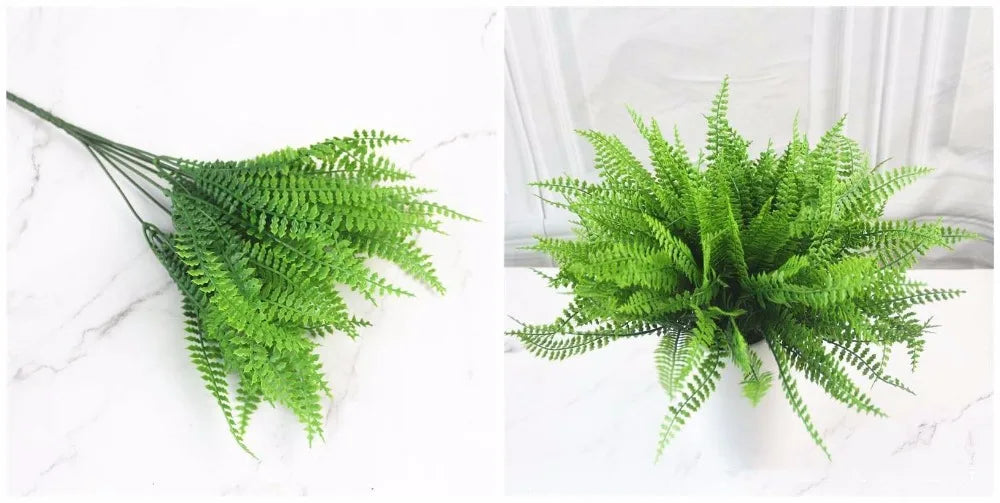 Artificial green fern branches shown as a loose stem and arranged in a white pot on a white marble surface.