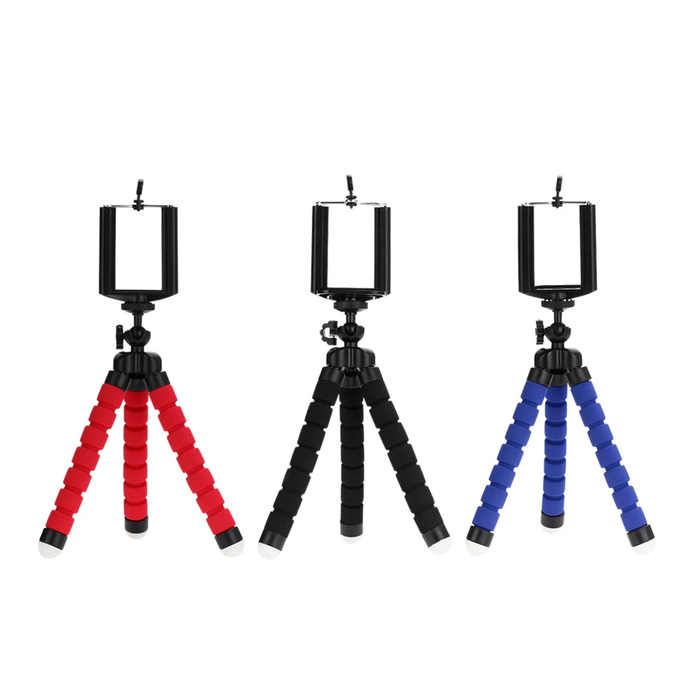 Three flexible mini tripods with foam legs in red, black, and blue, each featuring a smartphone mount.