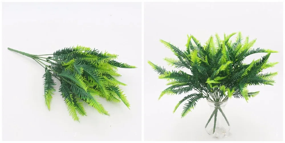Artificial fern branches with dark and light green variegated leaves, shown lying flat and arranged in a glass vase.