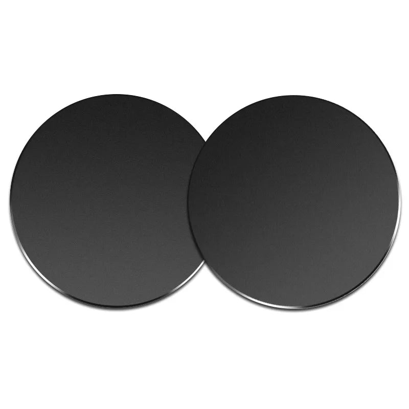 Two matte black circular coasters with a sleek, minimalist design.