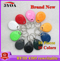 Ten multi-colored plastic RFID 4305 rewritable key fobs with metal key rings arranged in a circle.
