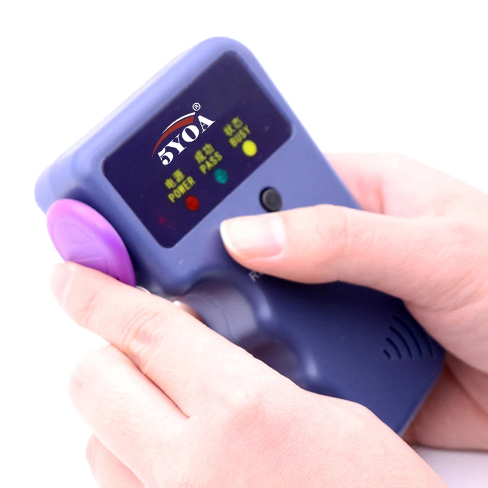 Handheld blue plastic RFID card copier with status indicator lights, held in hands against a white background.