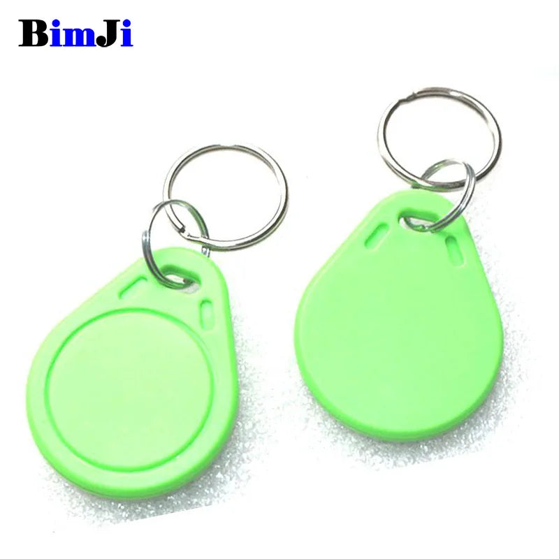 Two light green plastic RFID proximity key fobs with attached silver metal key rings.