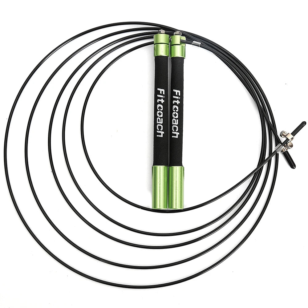Coiled black jump rope with green and black metal handles, labeled Fitcoach, and a steel cable.
