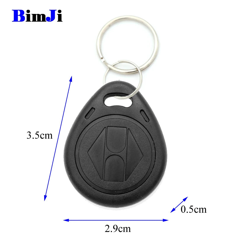 Black plastic teardrop-shaped RFID key fob with metal keyring and imprinted geometric pattern. 3.5cm by 2.9cm by 0.5cm.