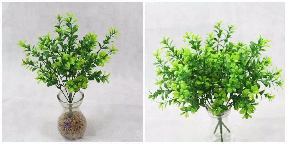 Two bouquets of vibrant green, artificial plastic leaf stems displayed in clear glass vases against a light background.