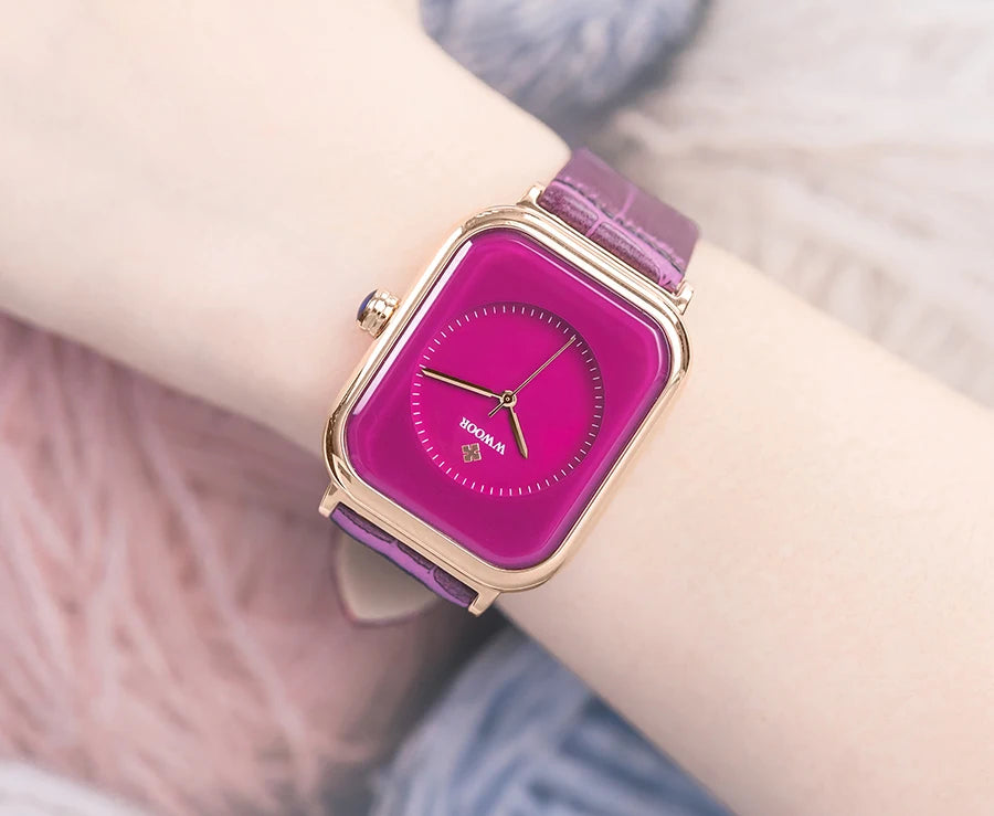 Ladies’ square watch with a vibrant magenta dial, rose-gold case, and textured purple leather strap.