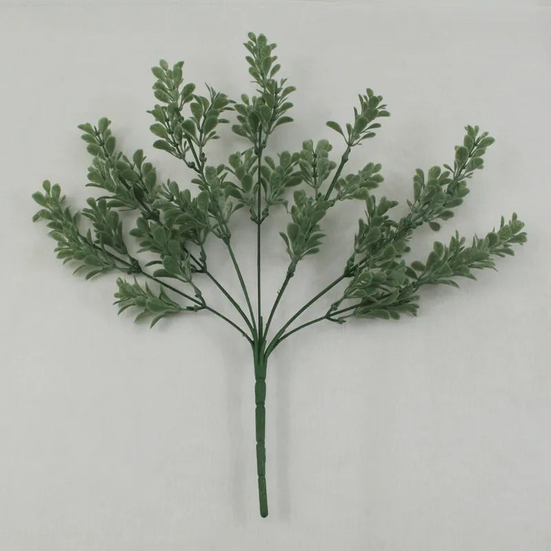 A single artificial greenery stem featuring multiple thin branches with small, sage-green textured leaves.