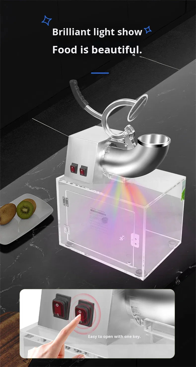 Silver electric ice shaver with a clear acrylic base and colorful LED light effects, operated by a side power switch.