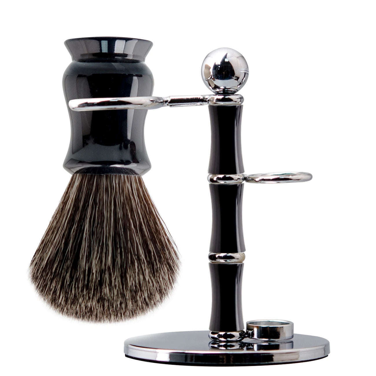 Luxury shaving kit featuring a black synthetic badger brush hanging on a chrome and black stand against a white background.