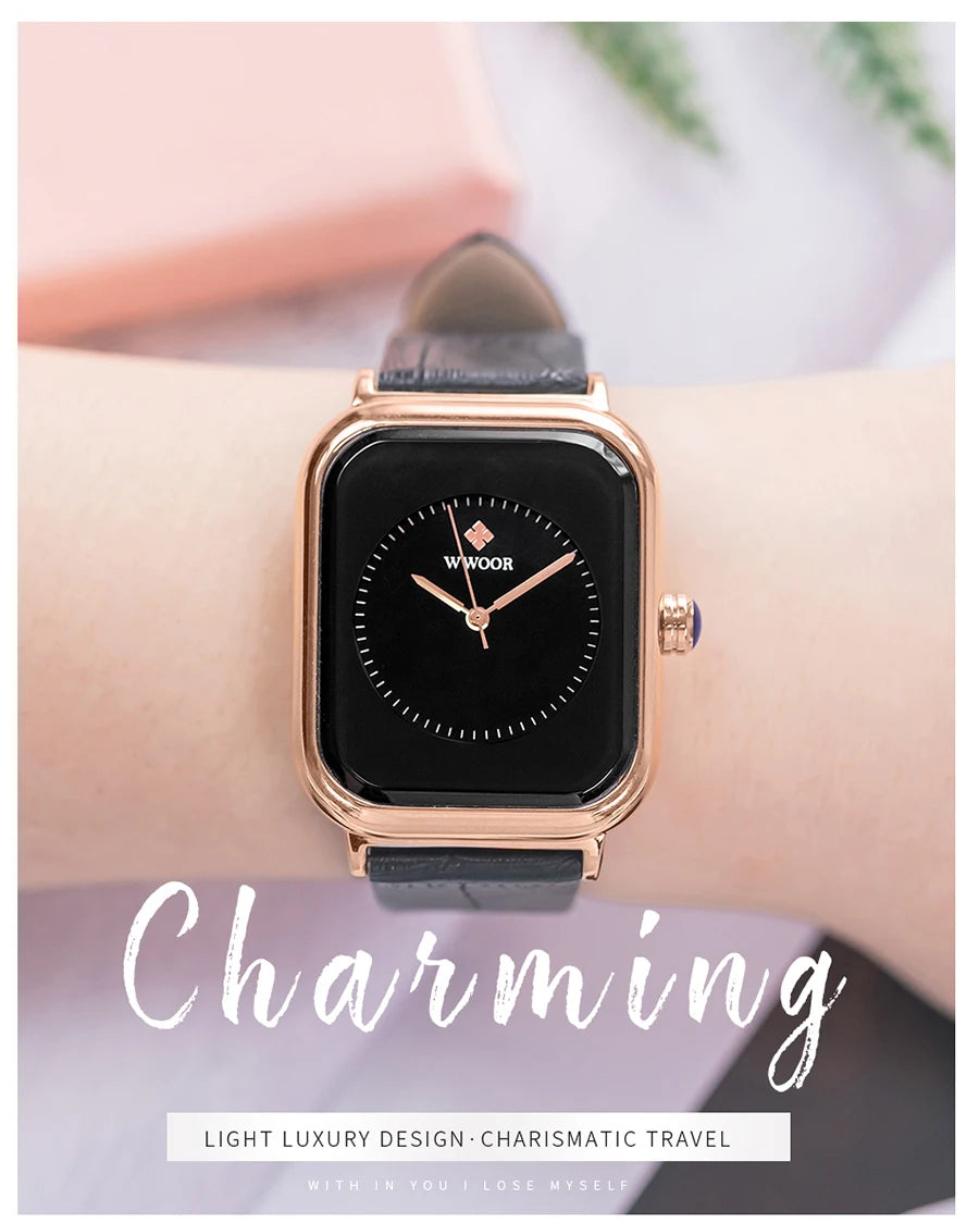 Elegant women's watch with a black square dial, rose-gold case, and textured black leather strap on a wrist.