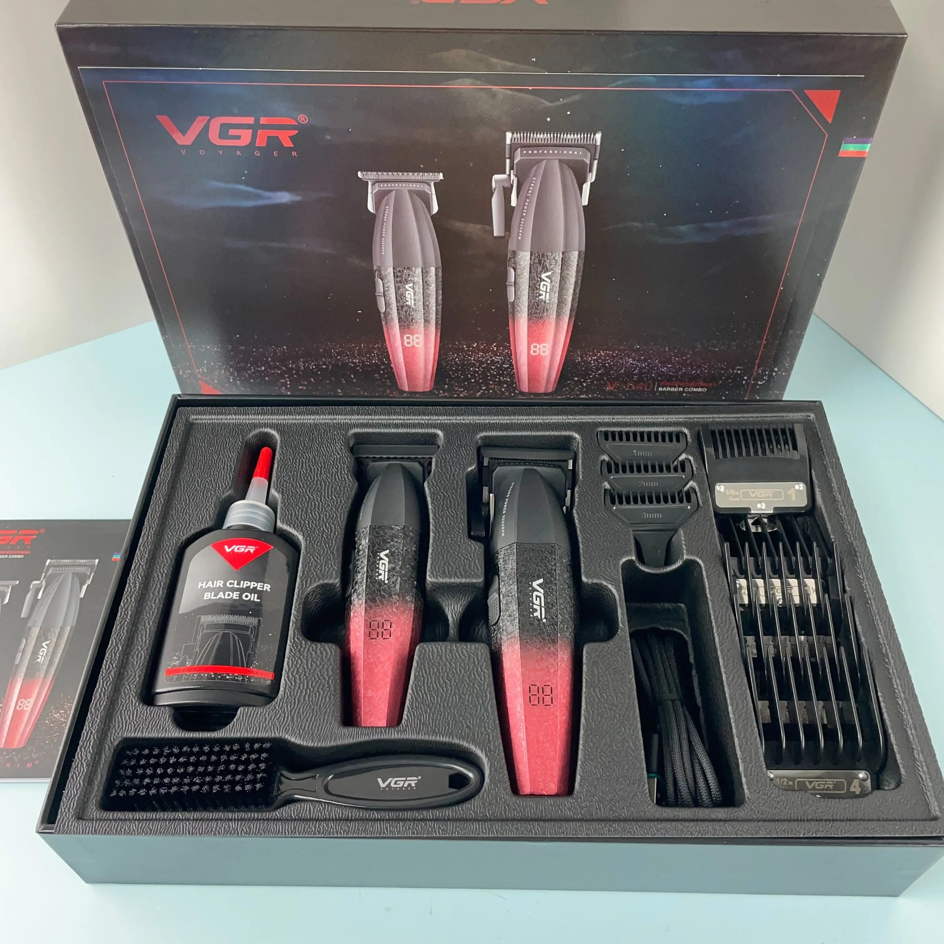 Professional cordless hair and beard trimmer set with black-to-red gradient finish, digital displays and accessories.