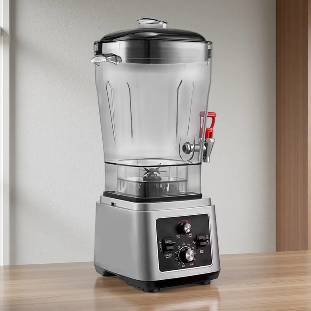 Professional stainless steel blender with a clear pitcher, built-in red dispenser tap, and black manual control panel.