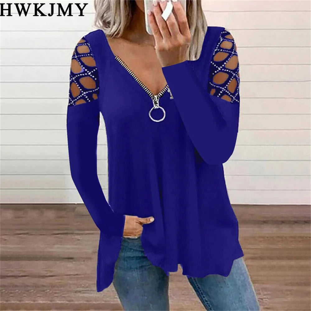 Royal blue long-sleeve top with zip-front neckline and cut-out, rhinestone-embellished shoulders.