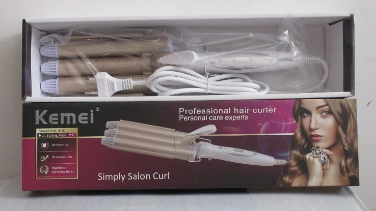 Gold and white triple-barrel hair waver with a white power cord, presented inside its retail packaging box.