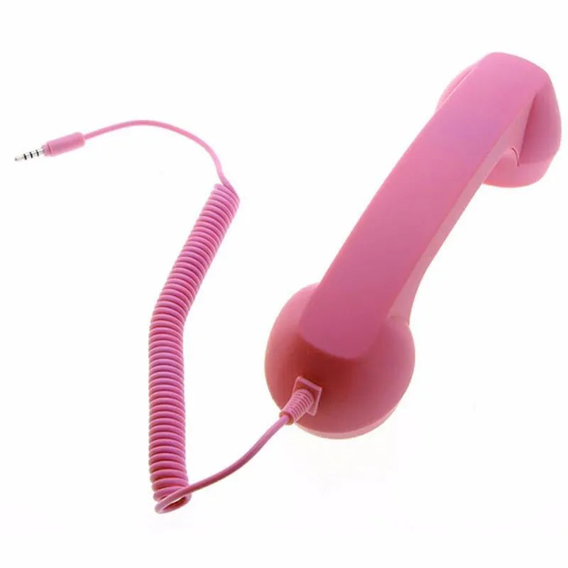 Bright pink retro-style telephone handset with a coiled cable and 3.5mm jack connector, set against a white background.