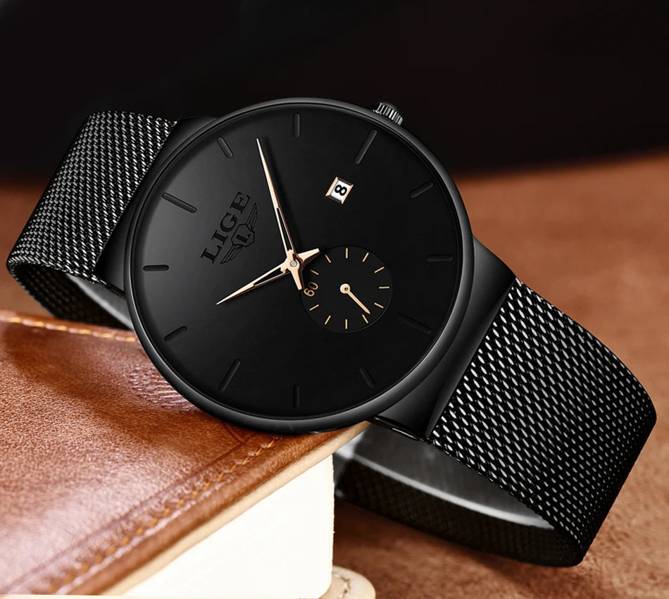 Ultra-thin women's quartz watch with a black dial, rose gold hands, date window and a black mesh stainless steel strap.