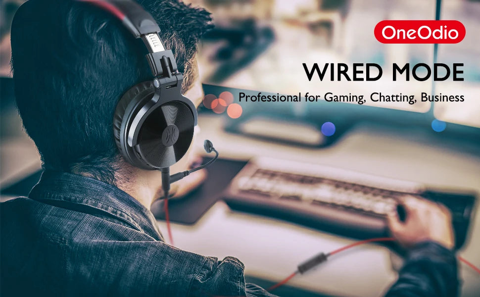 Person wearing sleek black over-ear headphones with a detachable boom microphone while using a computer.