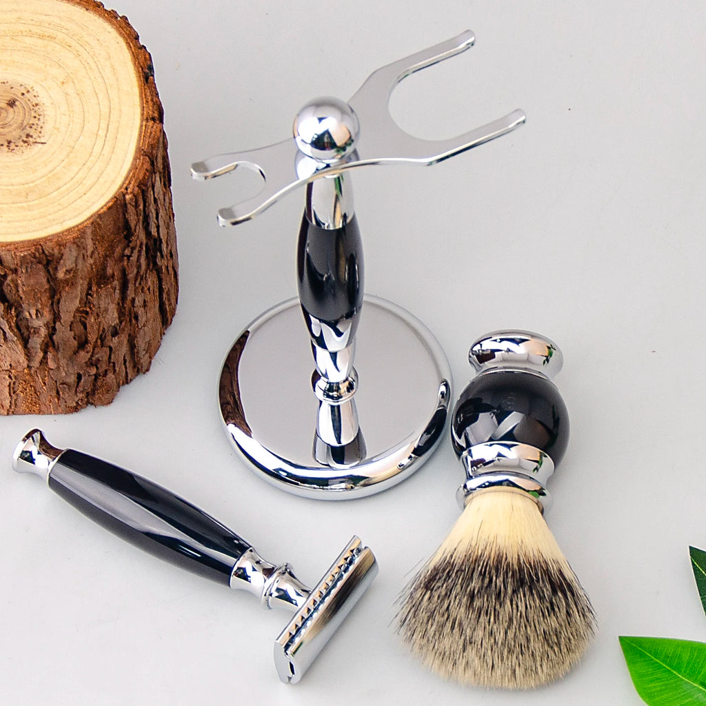 Safety razor and shaving brush set with glossy black and chrome handles, displayed on a chrome stand next to wood.