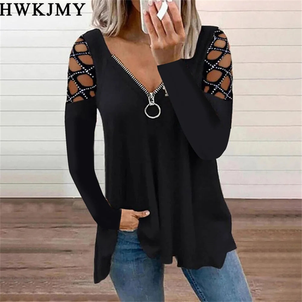 Black long-sleeve top with a zip-up V-neck and decorative cut-out lattice detailing on the shoulders.