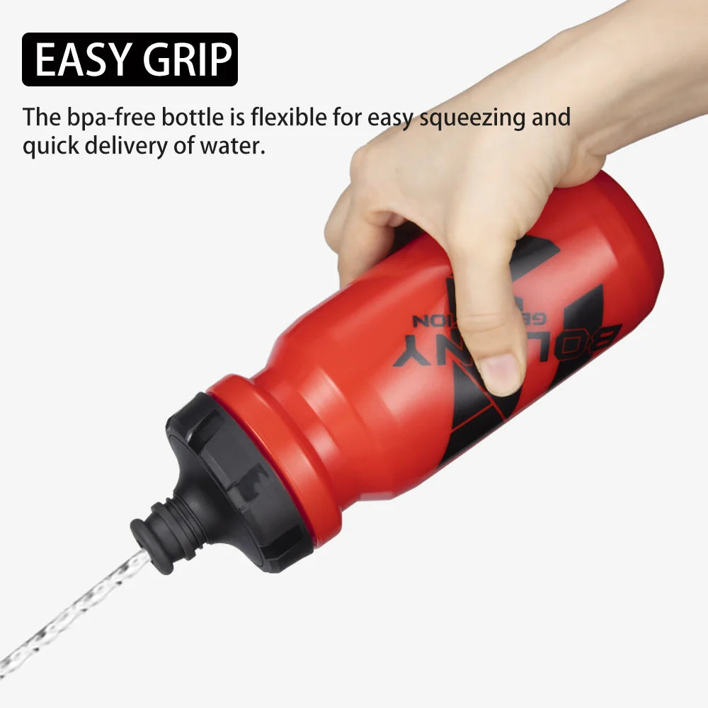 A hand squeezes a red, BPA-free sports water bottle with a black cap, spraying a stream of water.