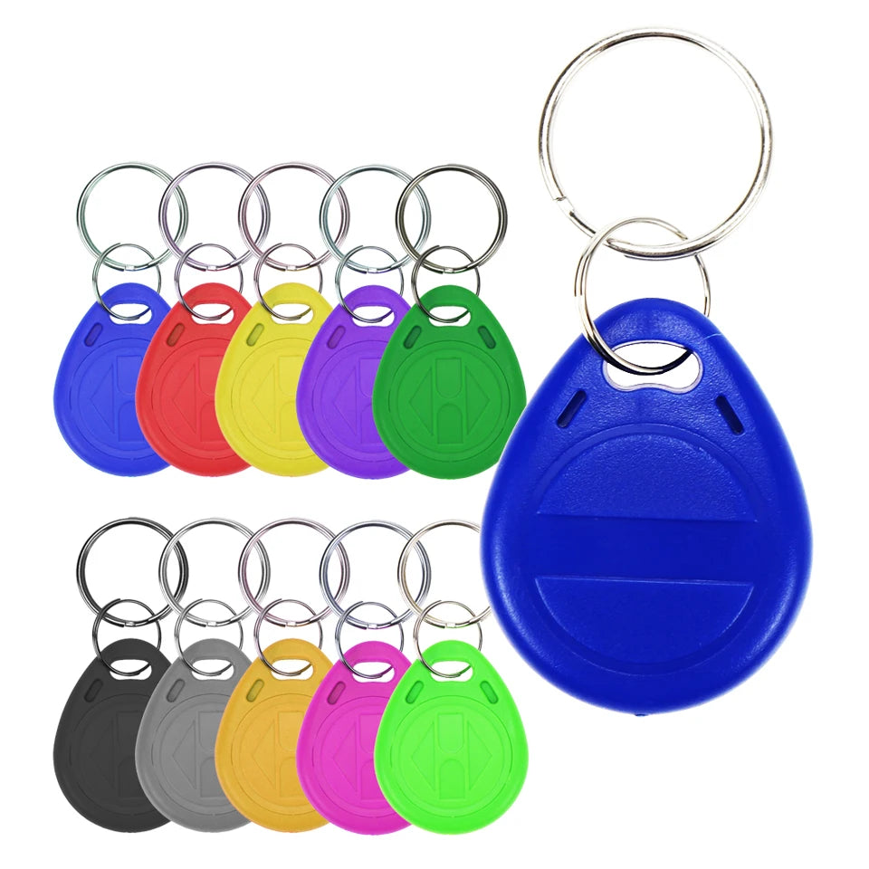 Set of multi-colored plastic teardrop-shaped RFID proximity key fobs with metal split rings on a white background.