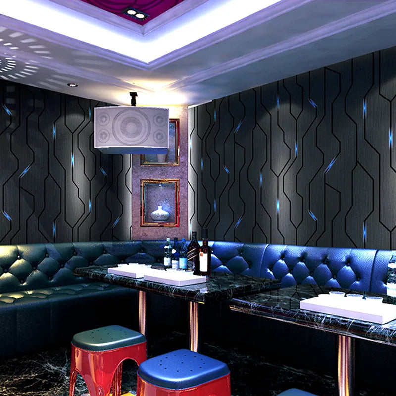 Modern charcoal wallpaper with 3D reflective geometric lines and subtle blue light accents in a contemporary lounge.