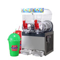 Commercial 2-bowl stainless steel slush machine with red taps, clear basins, and two slushy drinks in the foreground.